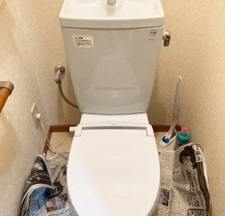トイレの床を新聞紙で養生している写真